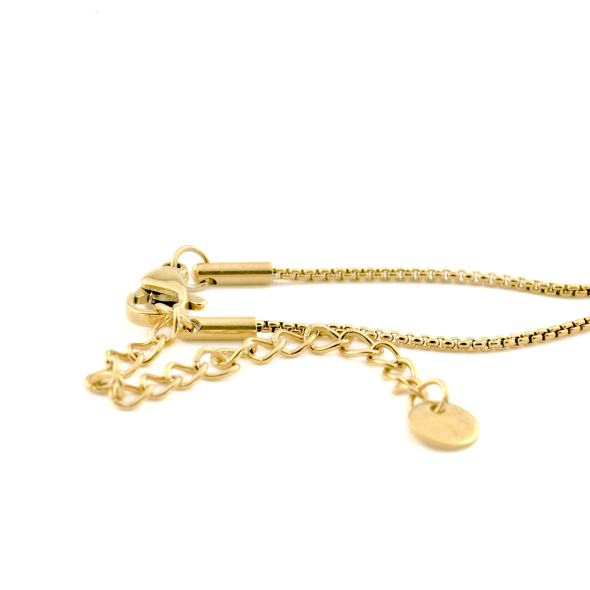 close-up to the rounded box chain showing the lobster clasp, extender chain with a tiny round stainless steel hallmark  charm on the end.