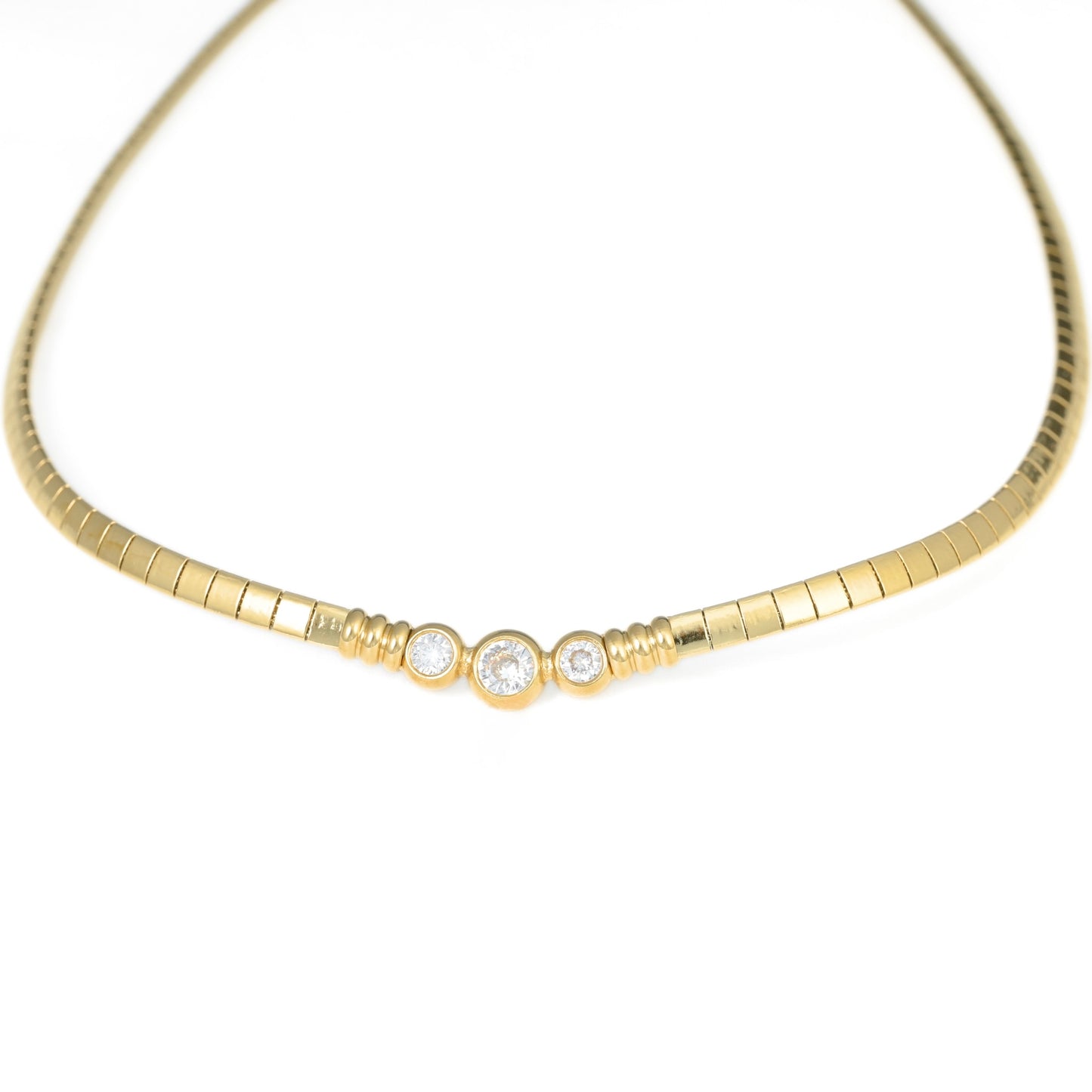 A yellow gold snake chain necklace featuring three bezel-set round clear stones in the center, displayed on a clean white background.