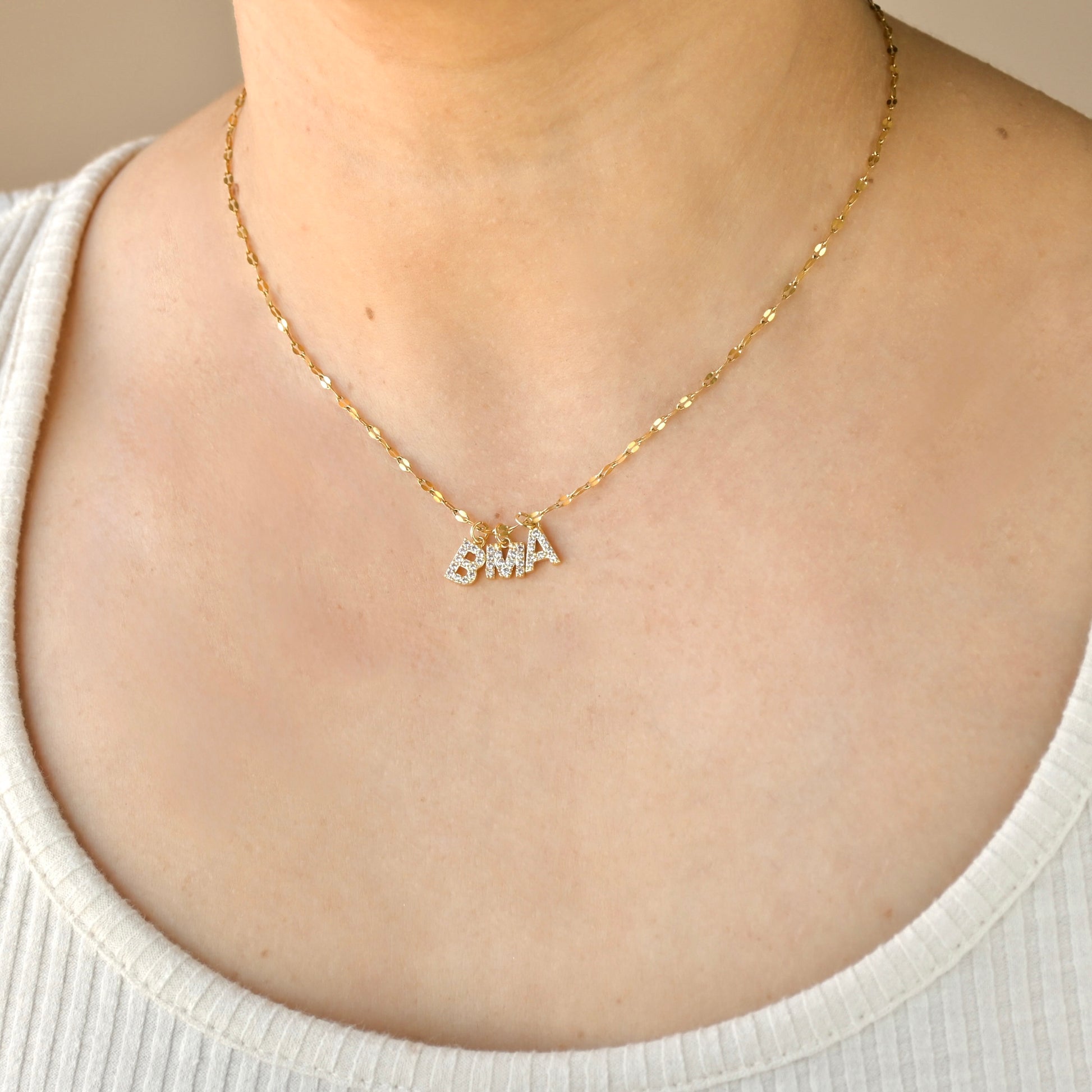 Dainty gold mariner chain necklace with three diamond initial pendants 'B', 'M' and 'A'