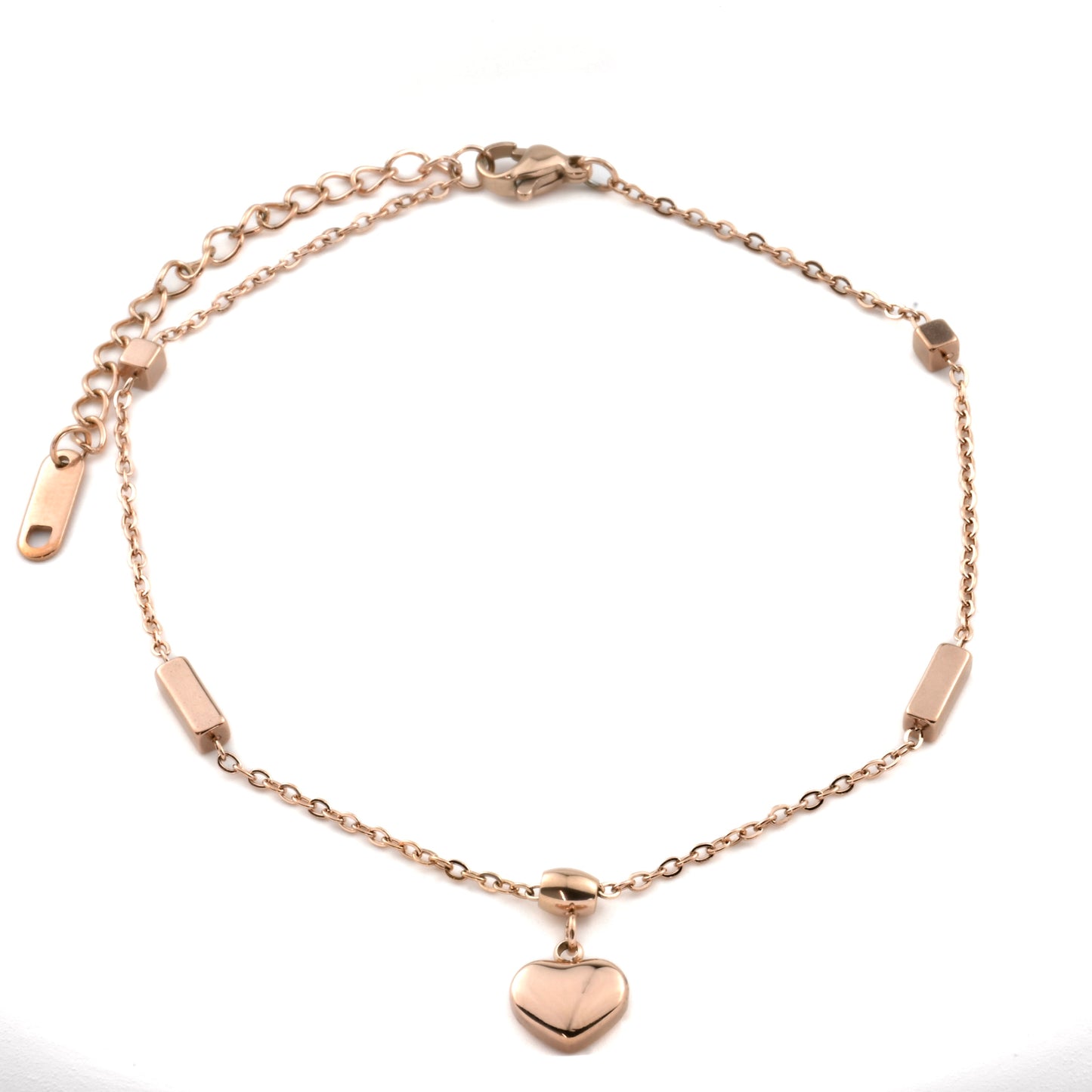 Top view of rose gold bracelet with a puffy heart charm on a white background