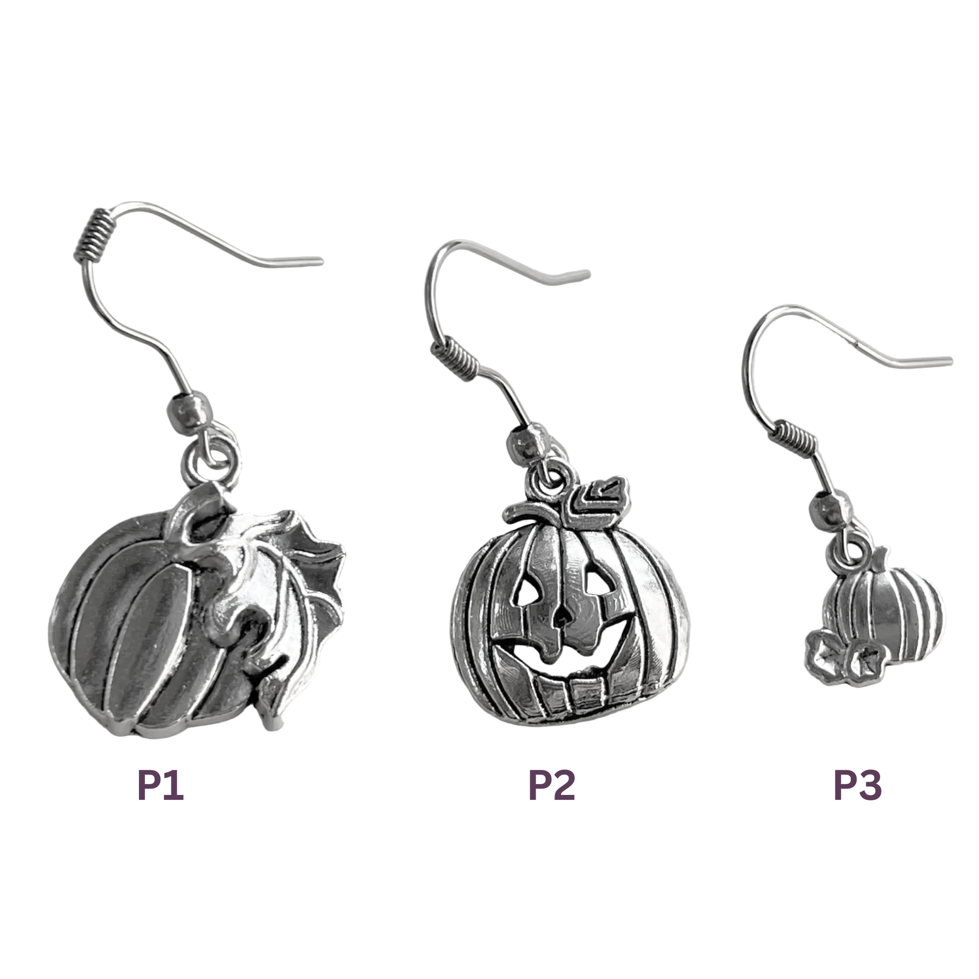 Three silver pumpkin earrings of different sizes on a white background