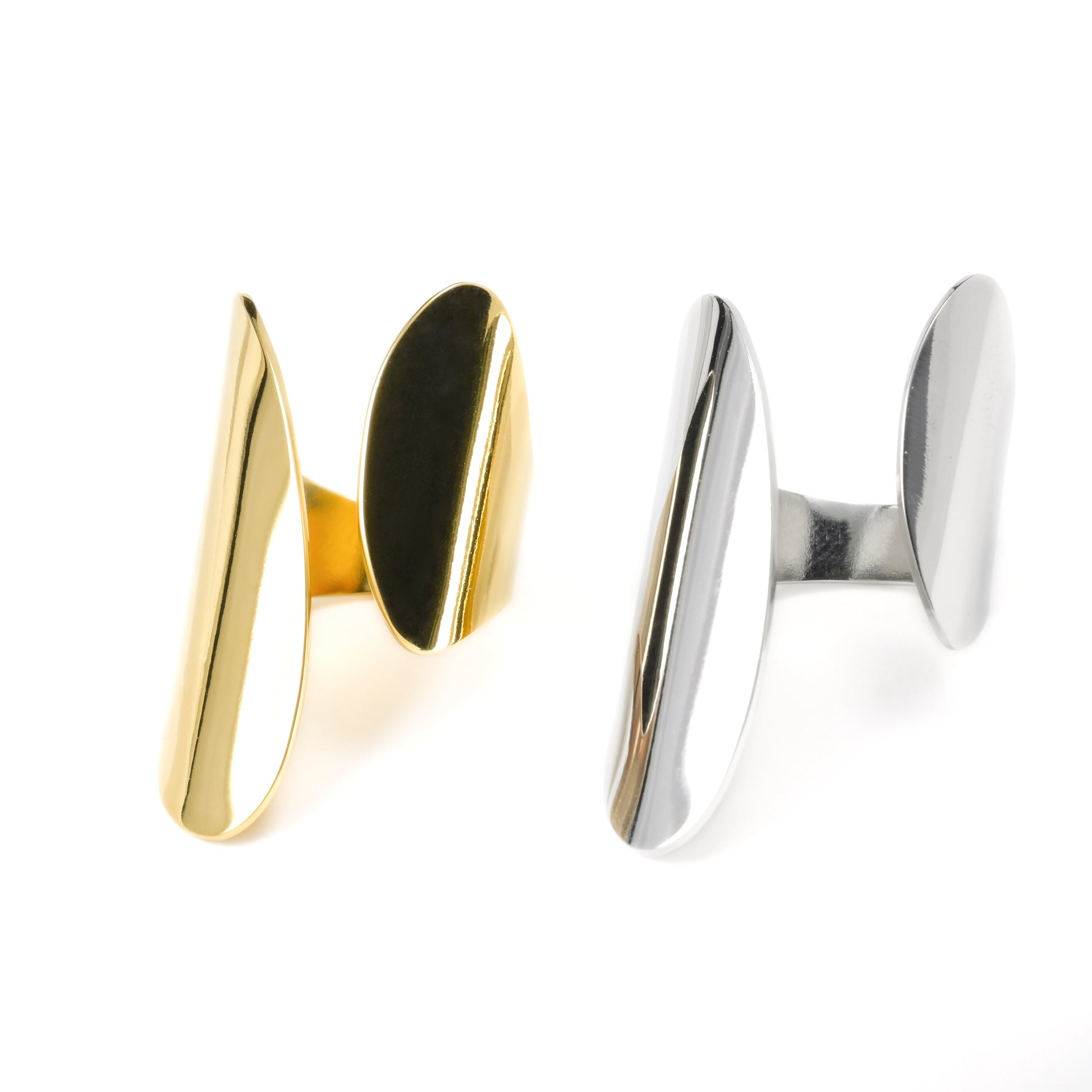 Wide Gold and silver cuff rings on a white background