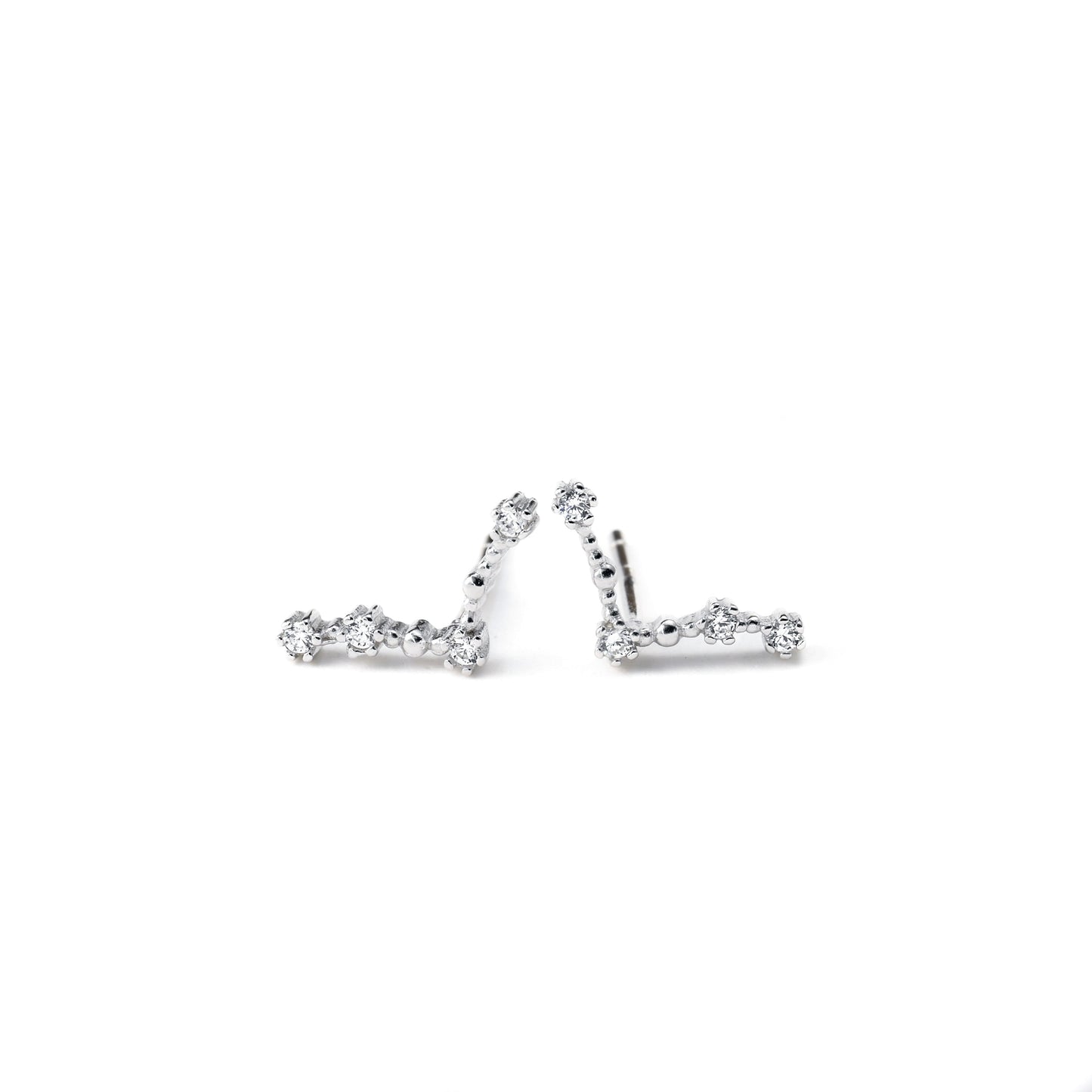 Pair of silver earrings with small diamonds on a white background