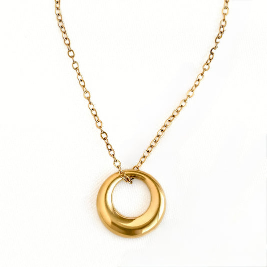 A gold chain necklace featuring a polished, open circular pendant, displayed against a clean white background.