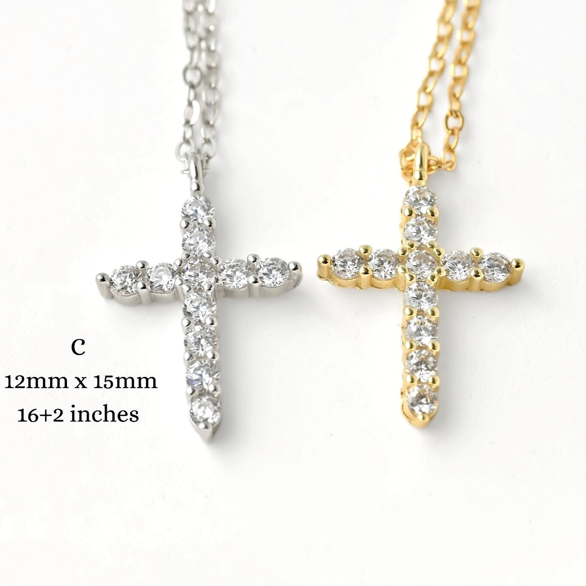 Two cross-shaped necklaces, one silver and one gold, with triangular edges, on a white background with size and length information.