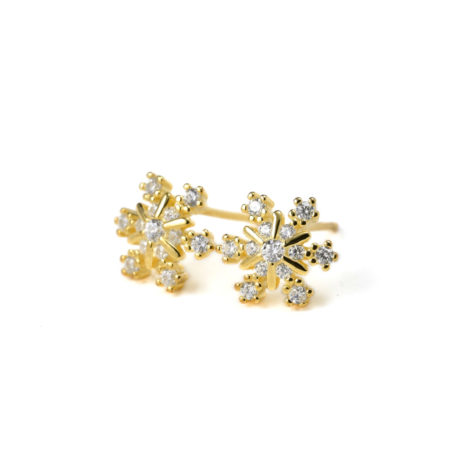Gold winter earrings with CZ stones on a white background