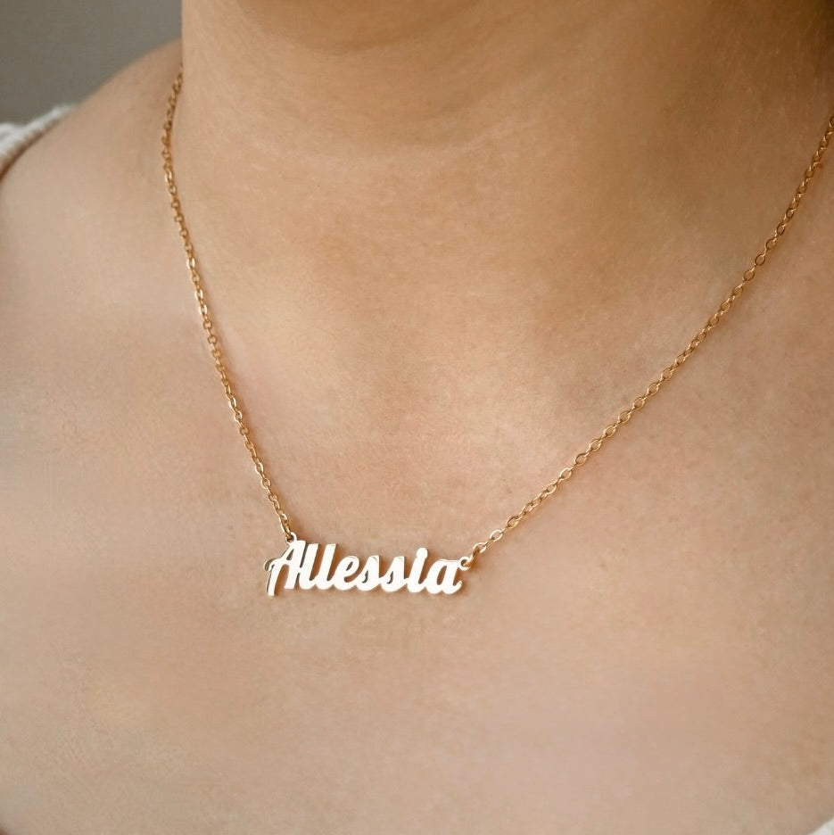 Gold nameplate necklace with 'Allessia' pendant on a person's neck