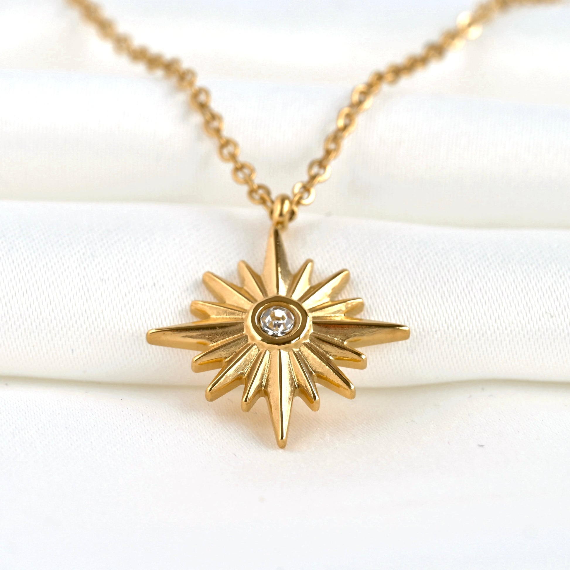 Close up front view showing the intricate starburst pattern on the pendant 