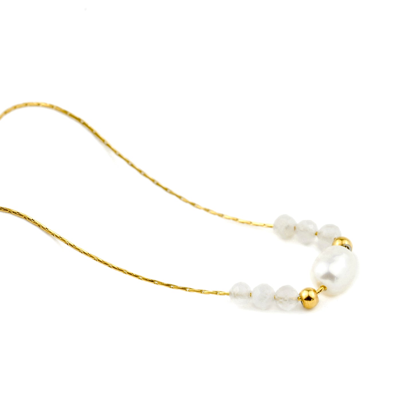 Pearl necklace with gold and white bead accents on a white background