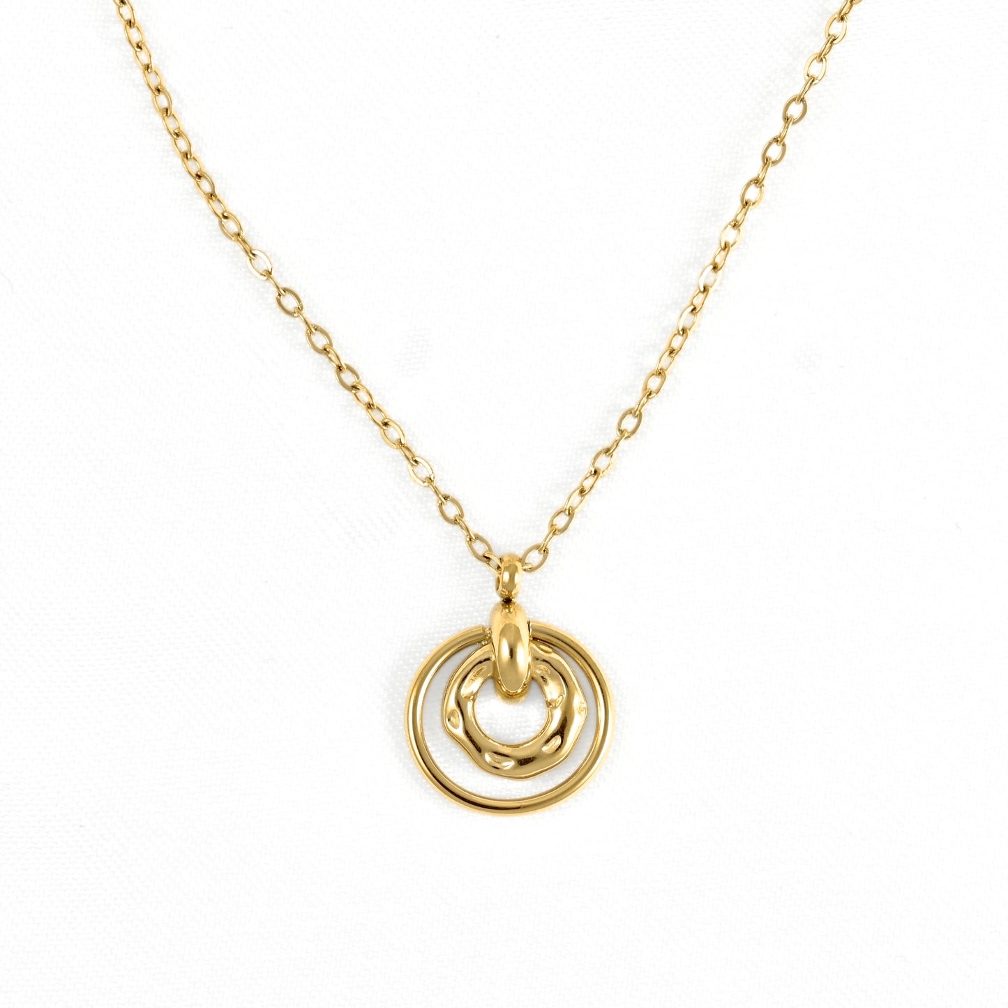 A delicate gold chain necklace featuring a pendant with two interlocking, overlapping circular rings, photographed against a clean white background.
