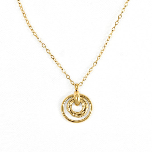 A delicate gold chain necklace featuring a pendant with two interlocking, overlapping circular rings, photographed against a clean white background.