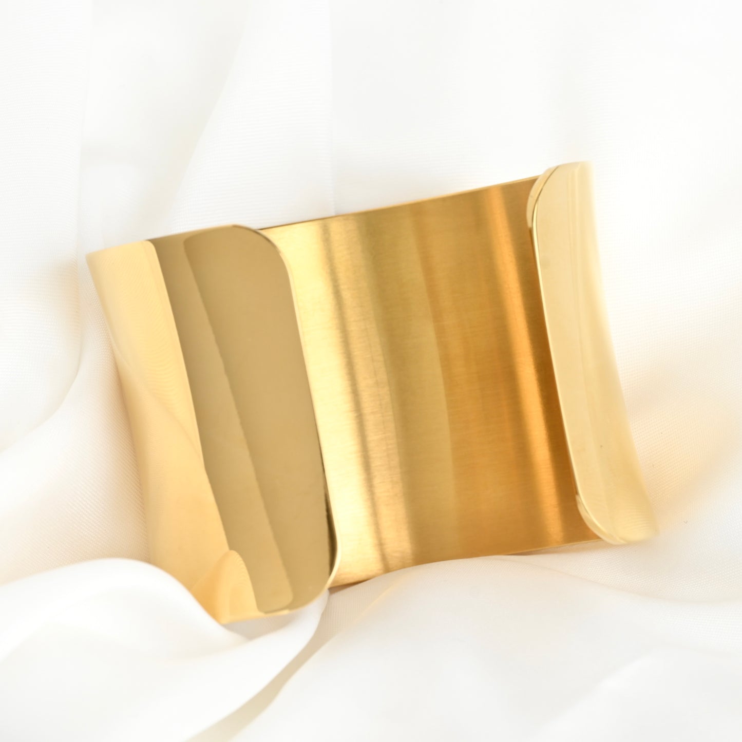 Sculptural Gold bangle on a white background
