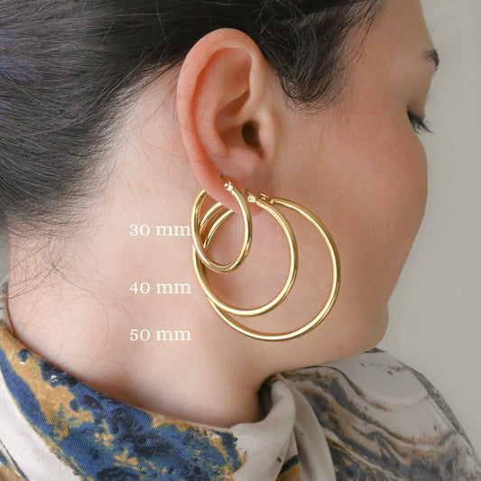 3mm Thick Gold hoop earrings worn by a person with measurements indicated on the image.