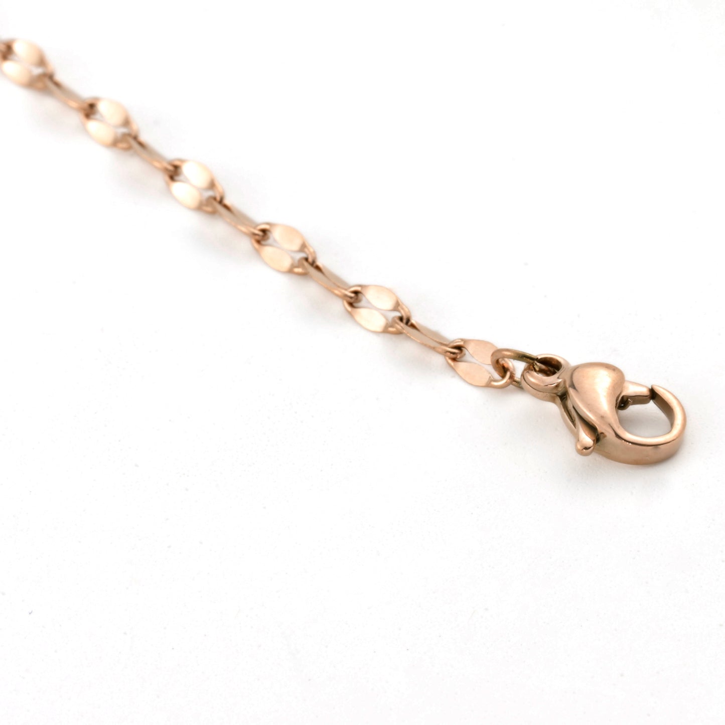 Rose gold chain  anklet with a clasp on a white background