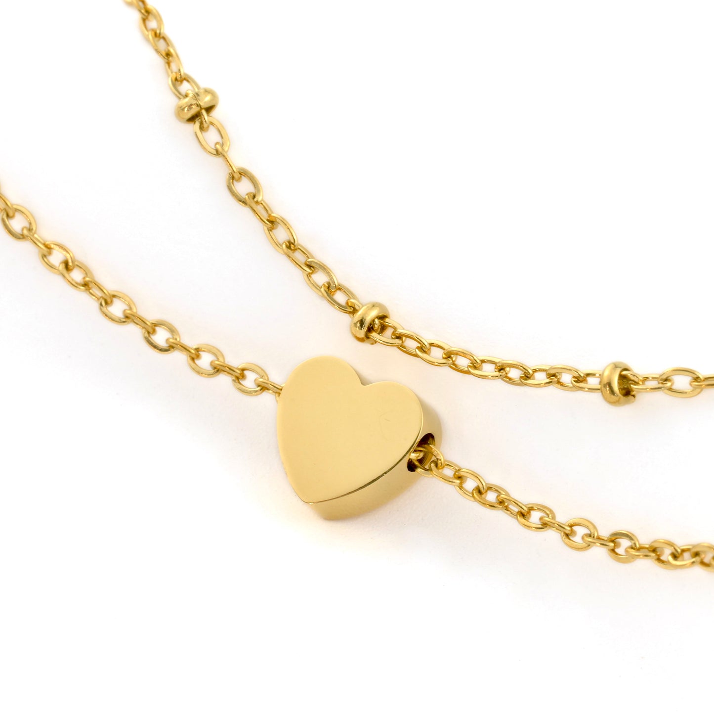 Gold heart anklet on a gold chain against a white background
