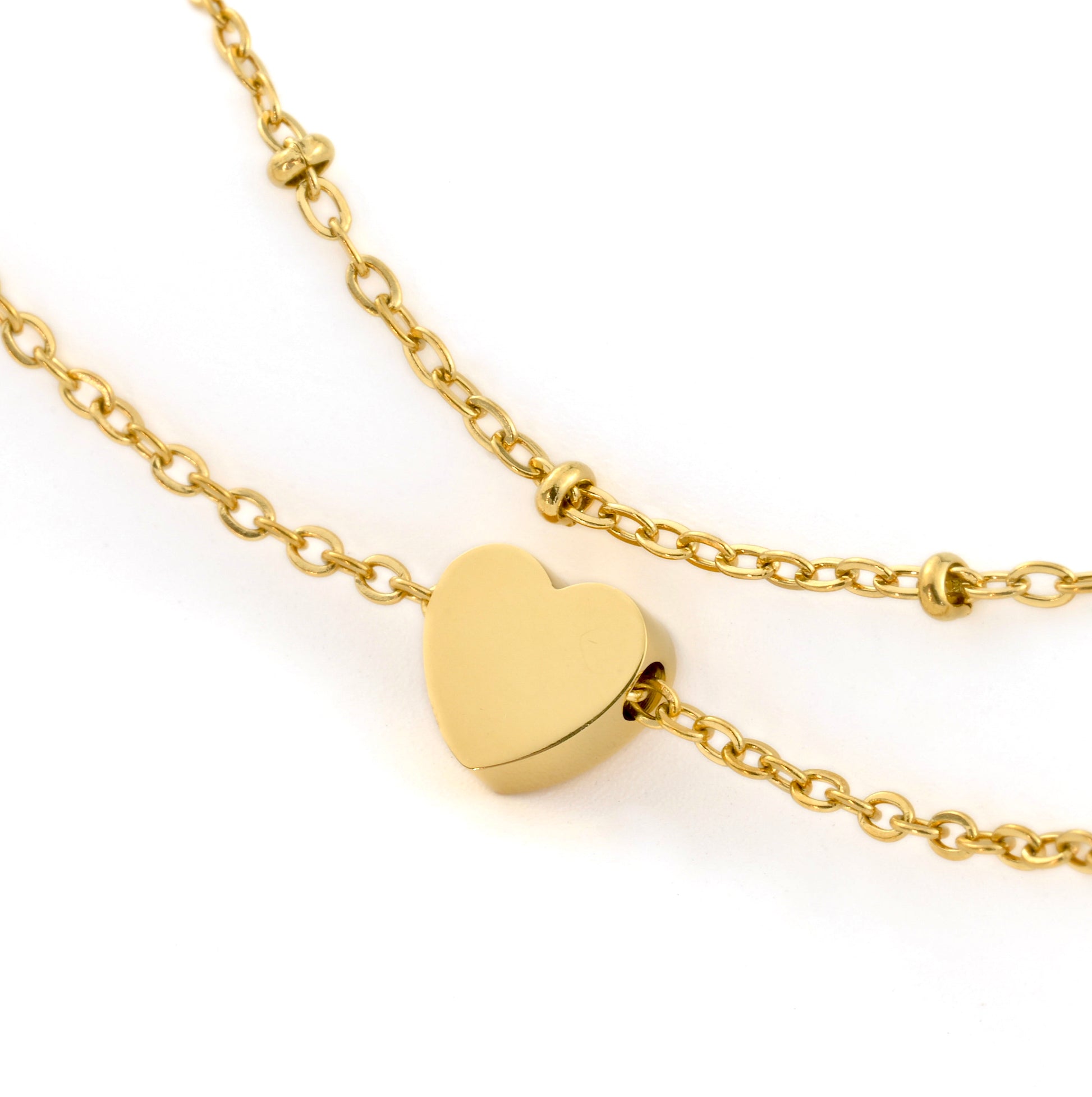 Gold heart anklet on a gold chain against a white background