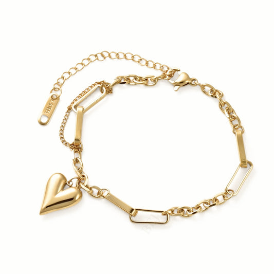 A gold-plated chain bracelet featuring a polished heart charm, rectangular bar links, and an extender chain with a lobster clasp, shown on a plain white background.
