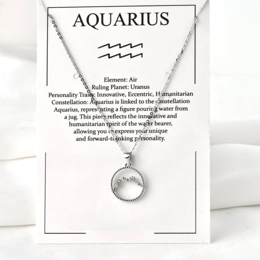 Silver necklace with Aquarius zodiac symbol on a white jewelry card with text
