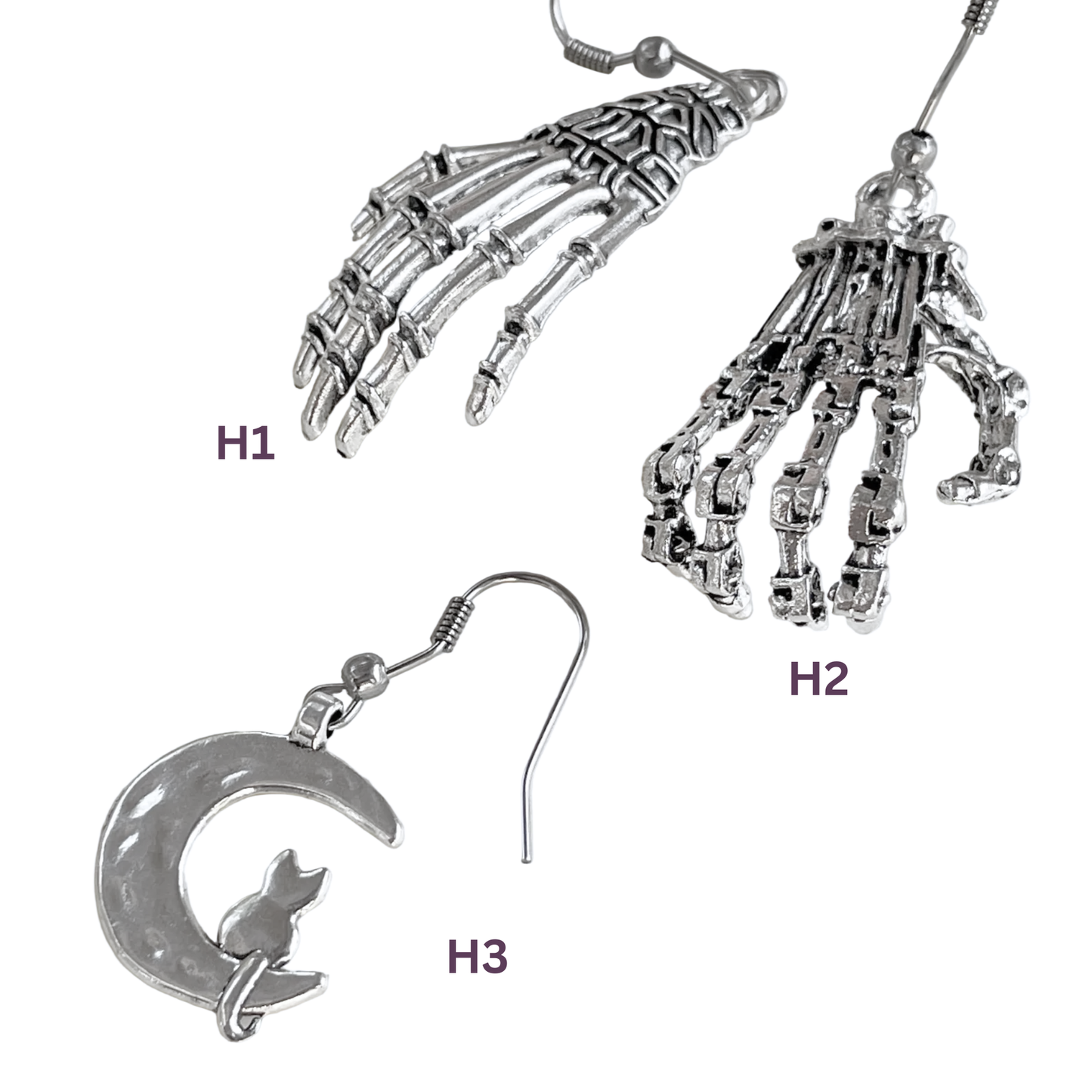 Two pairs of silver skeleton hand earrings  and cat earrings on a white background.