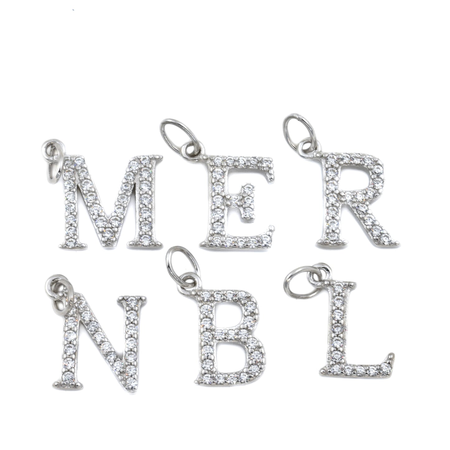 Silver letter charms on a white background