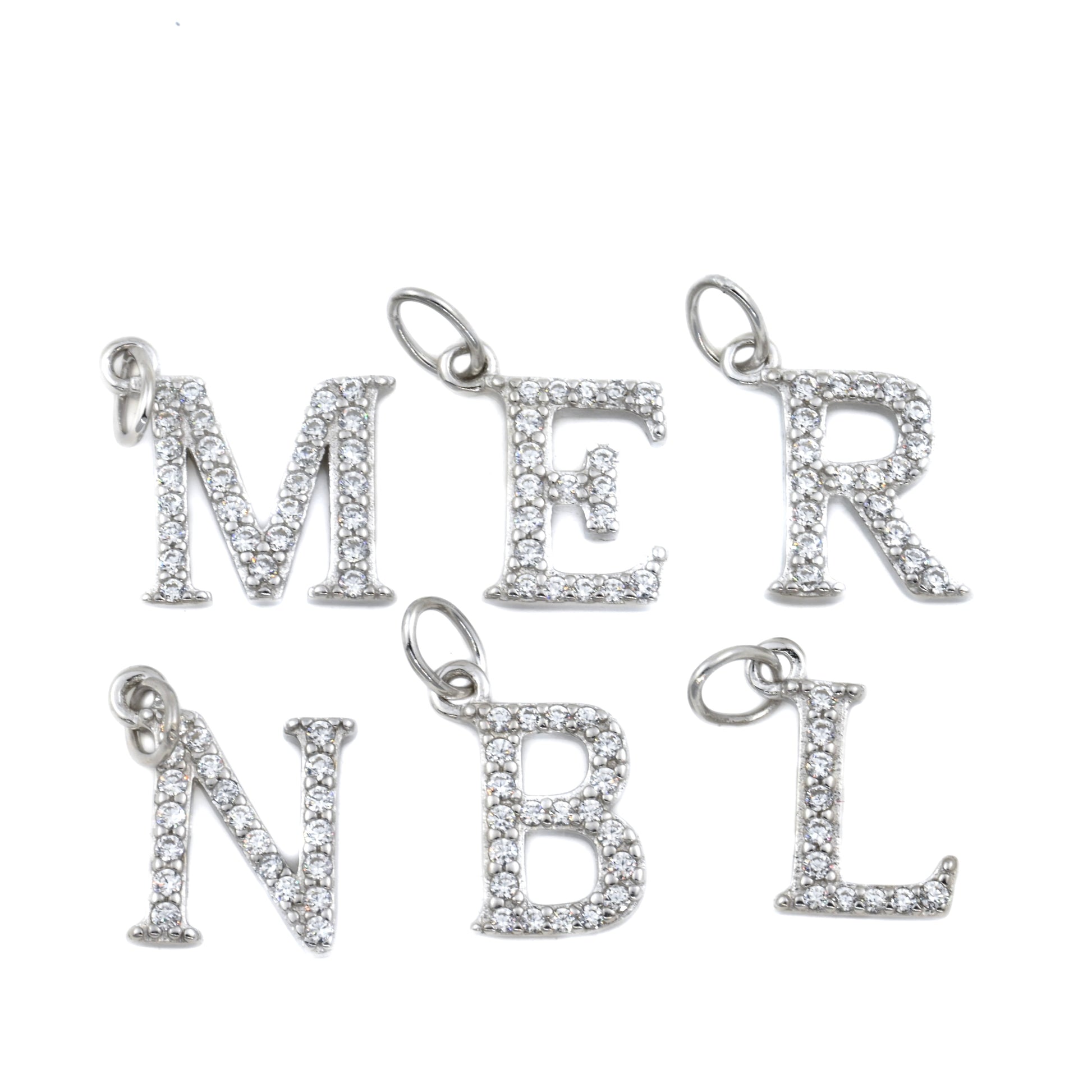 Silver letter charms on a white background