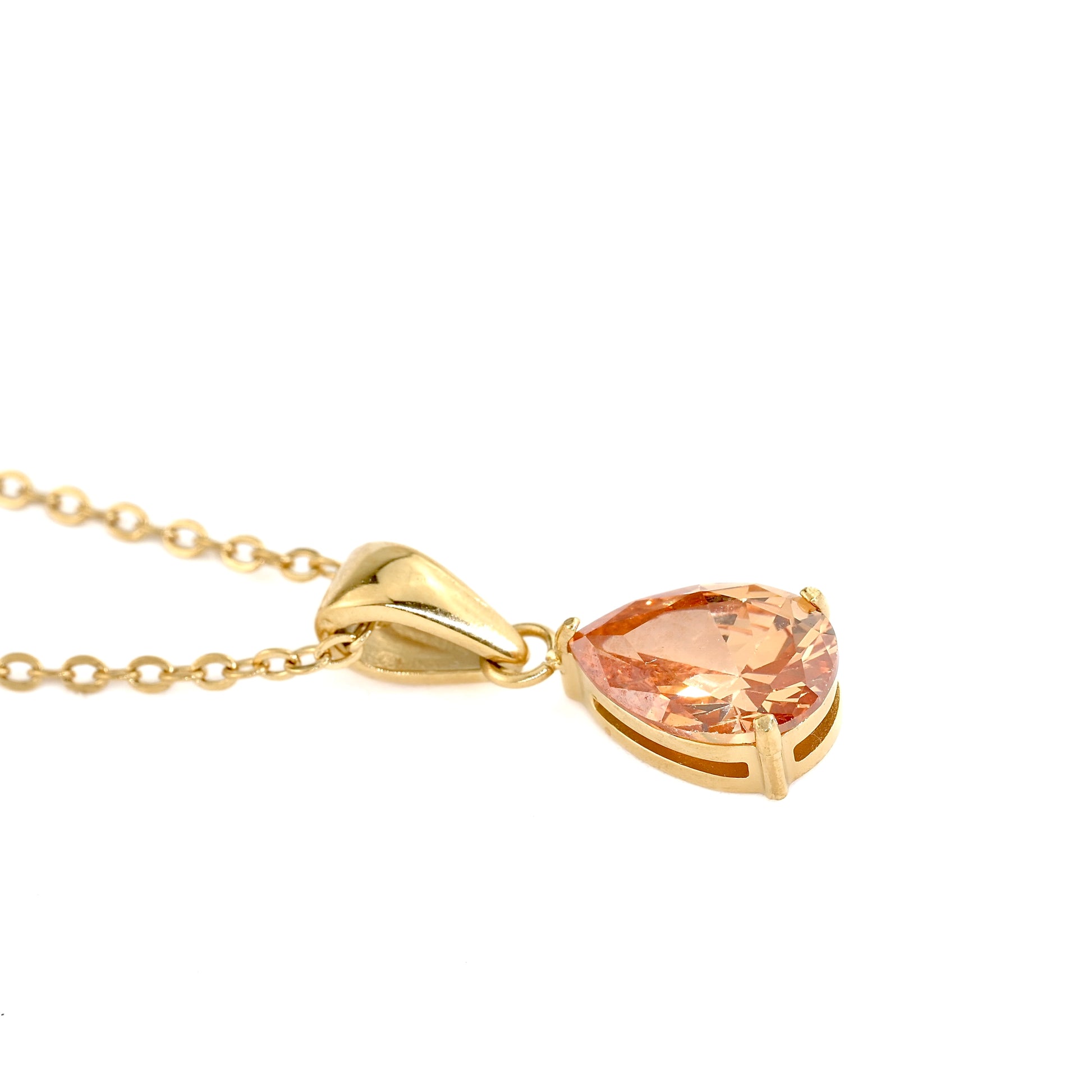 gold necklace with pear cut november birthstone 'topaz' on a white background