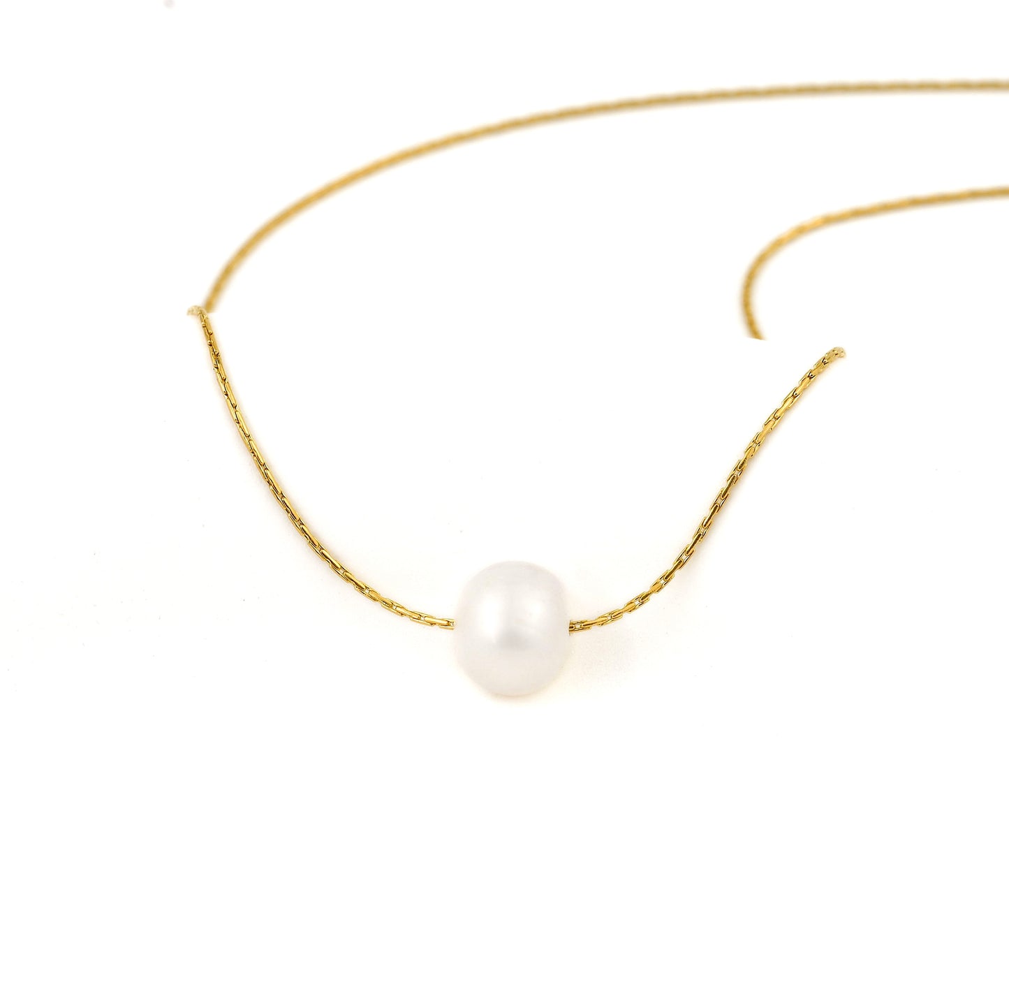 front view of a Gold necklace with a single pearl on a white background