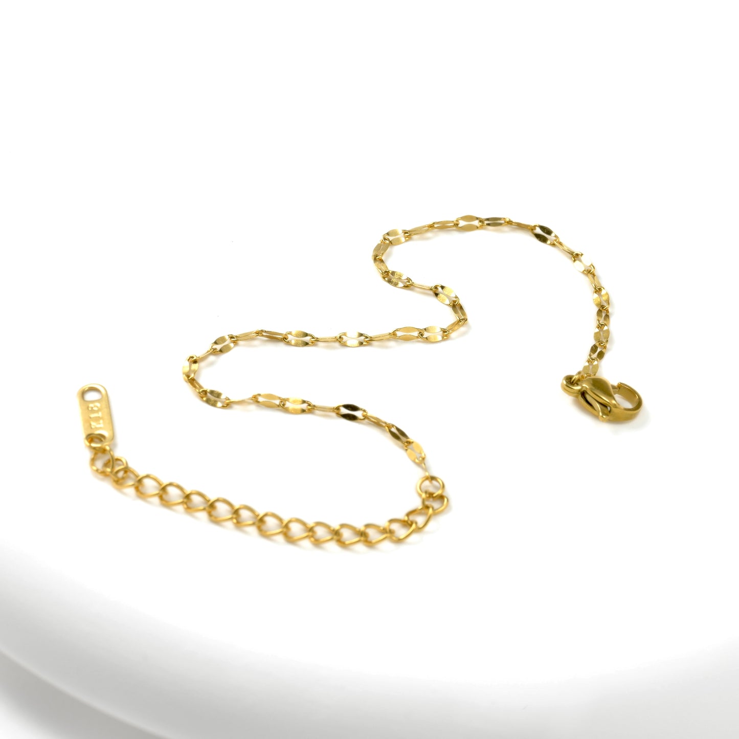 dainty gold jewelry on a white background
