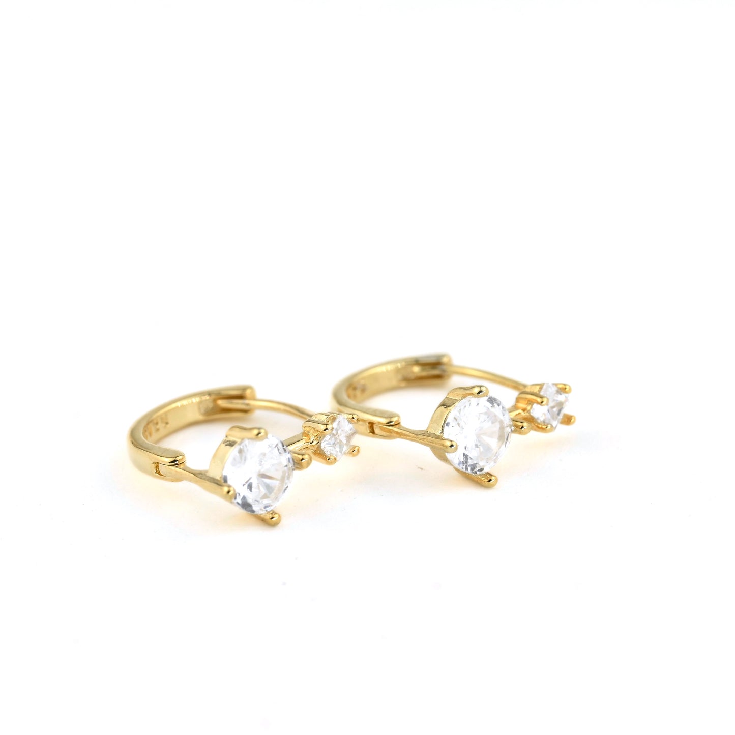 Gold ring with clear gemstones on a white background with S925 stamp on metal