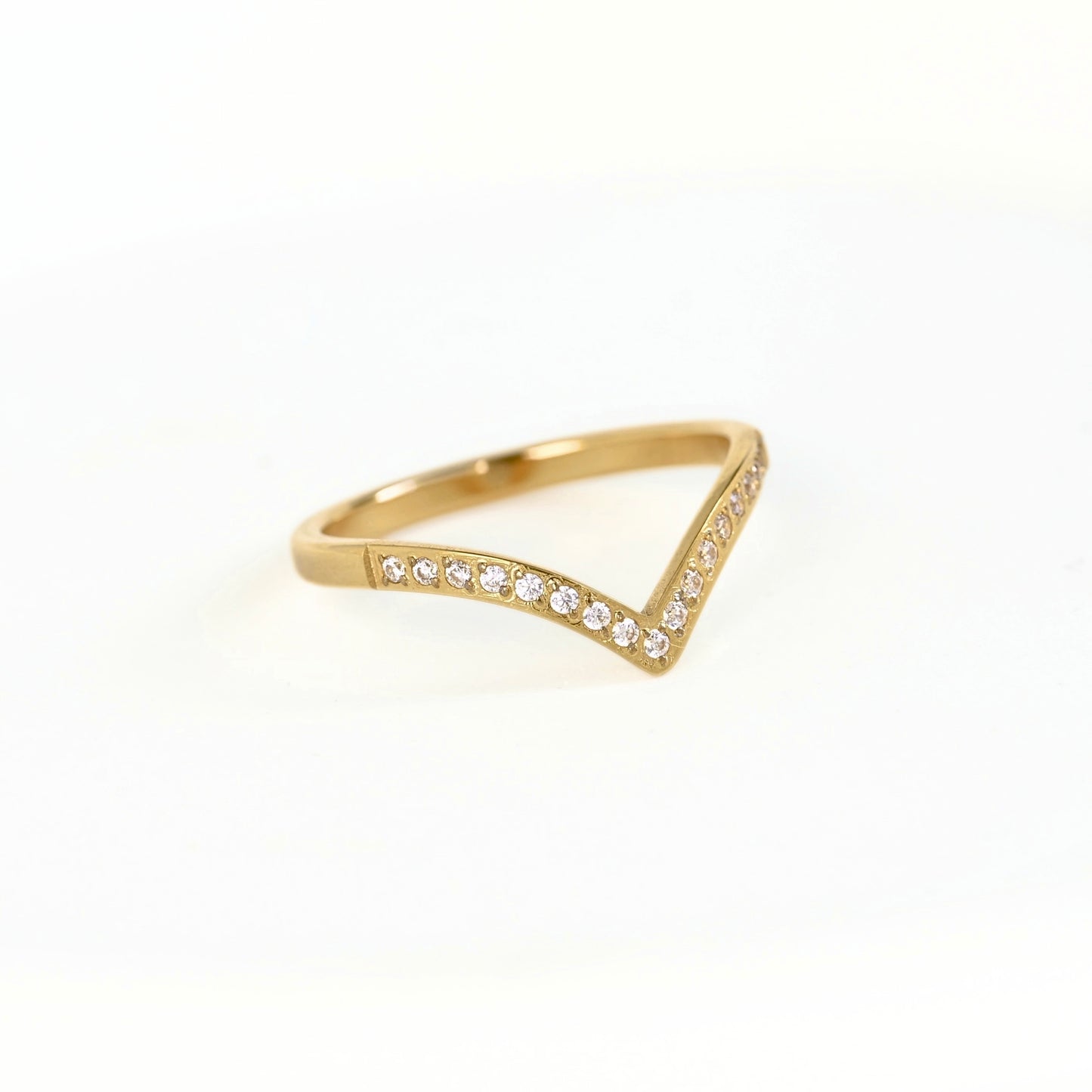 A gold triangular ring with small clear stones set along the front edge, photographed on a clean white background.