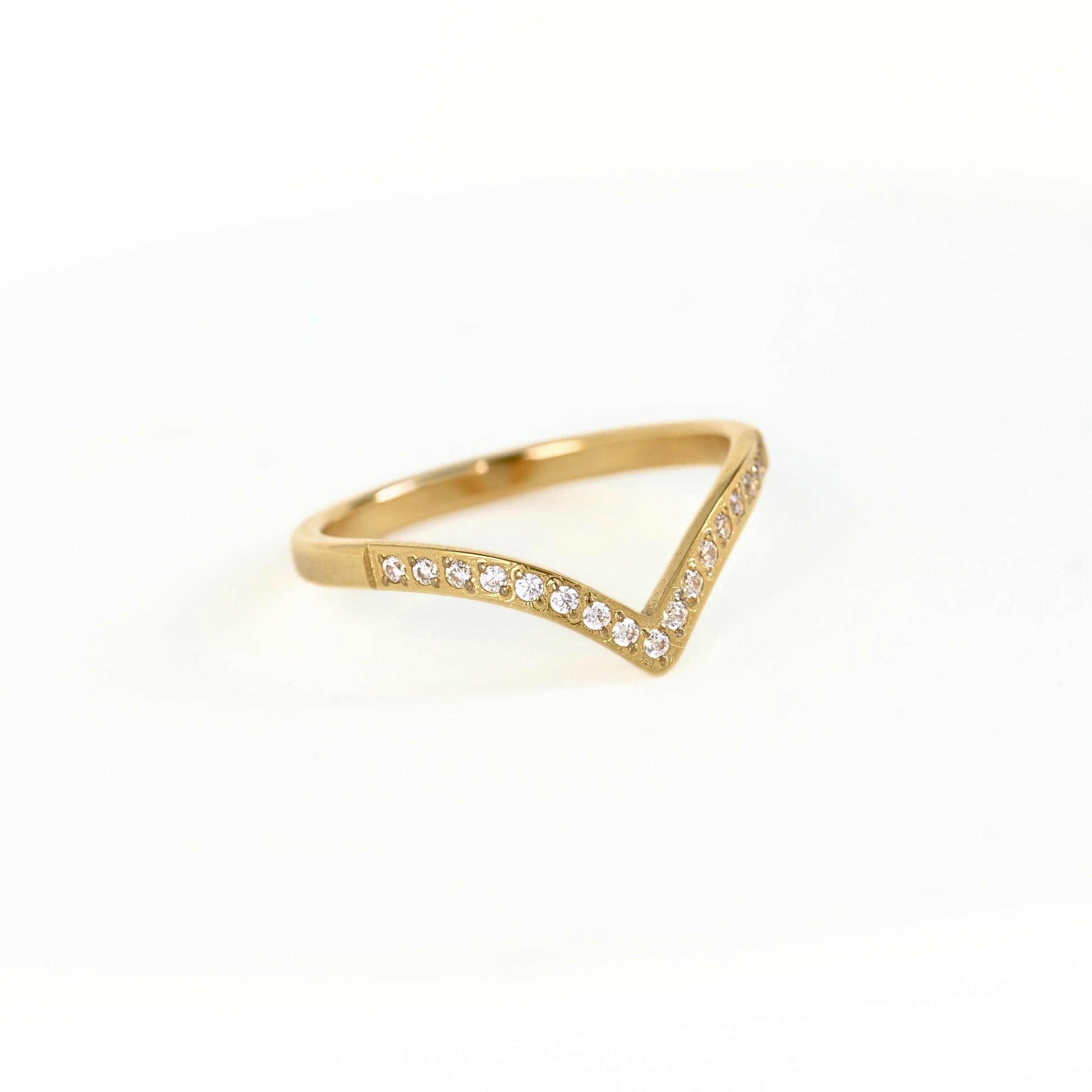 A gold triangular ring with small clear stones set along the front edge, photographed on a clean white background.