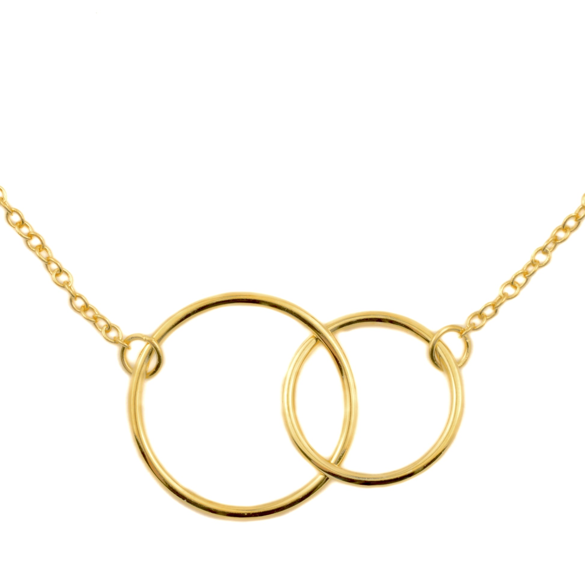 Gold necklace with two interlocking hoops on a white background