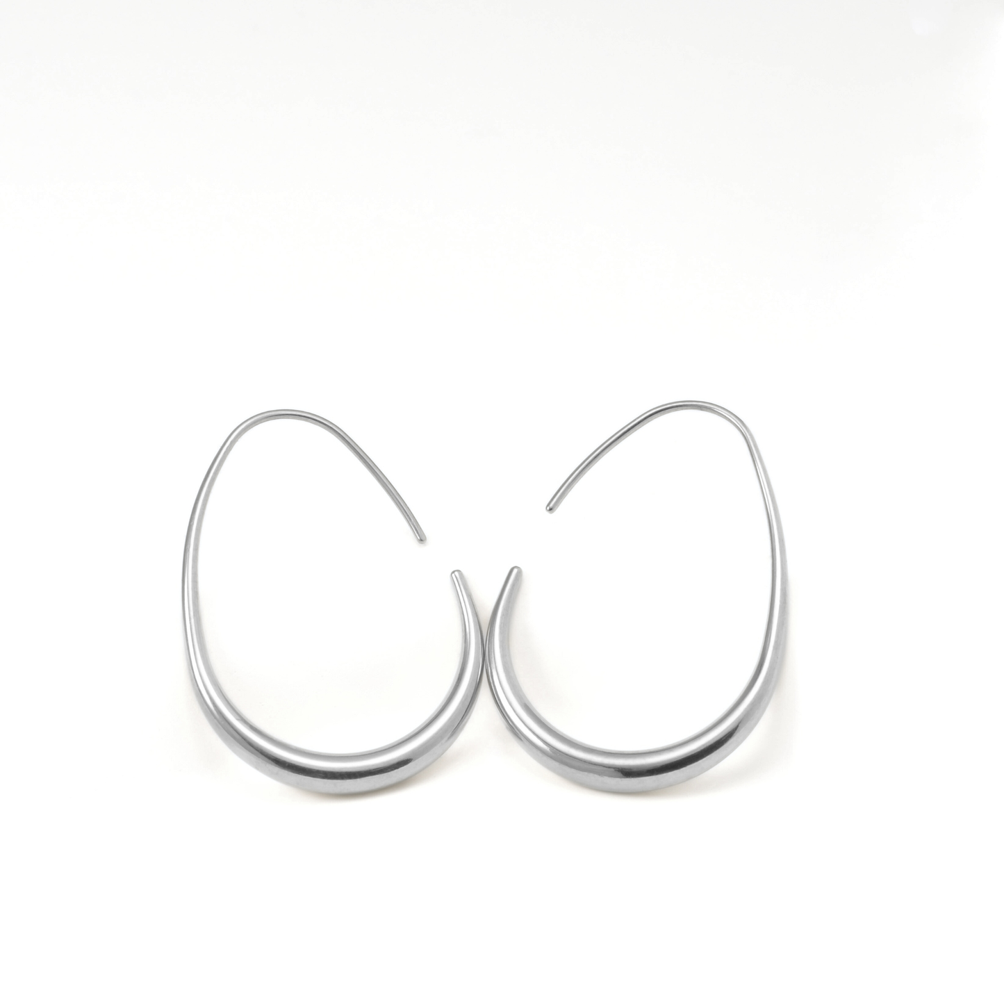 Pair of large silver hoop earrings with a hook clasp on a white background