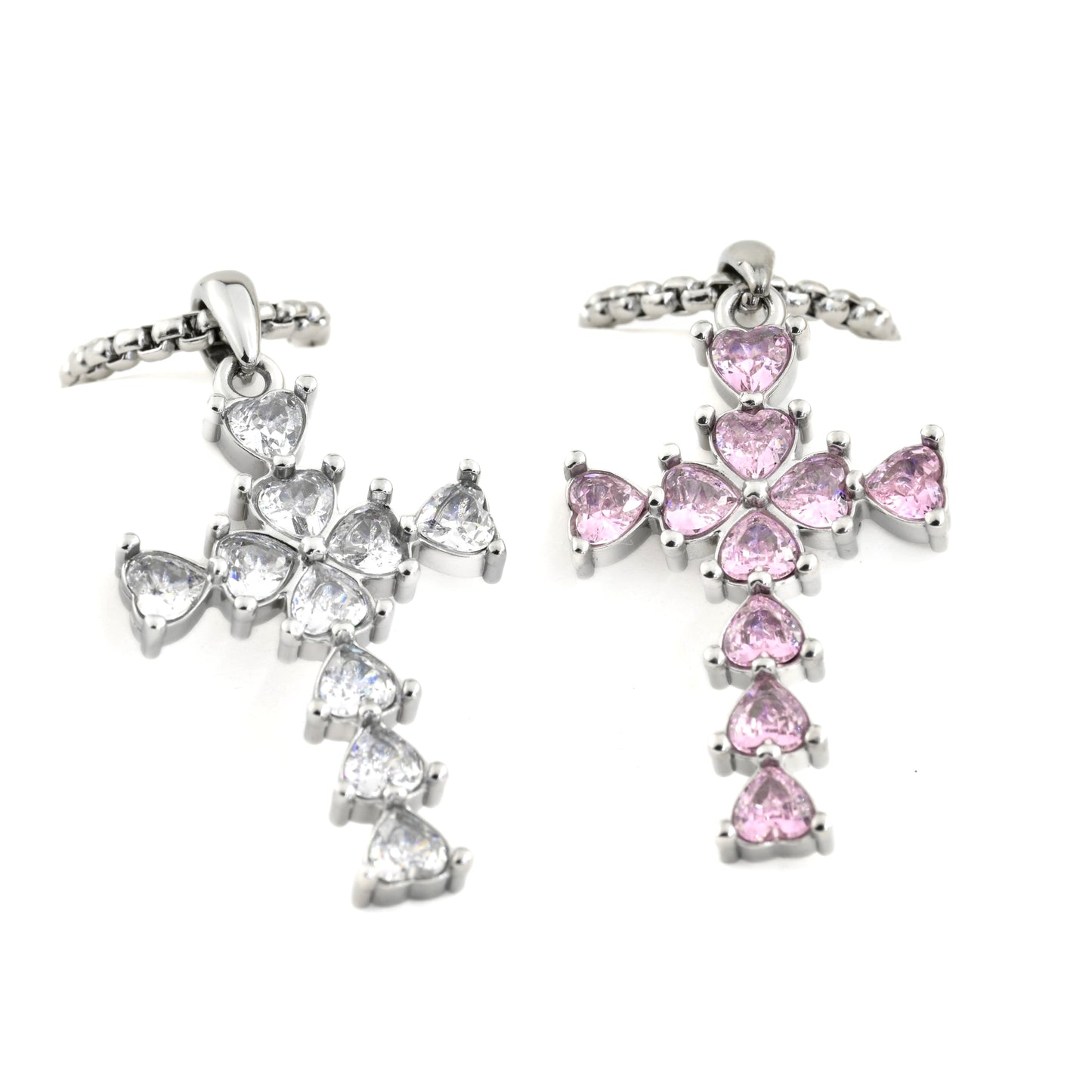 Oversized cross necklaces with pink and clear gemstones on a white background