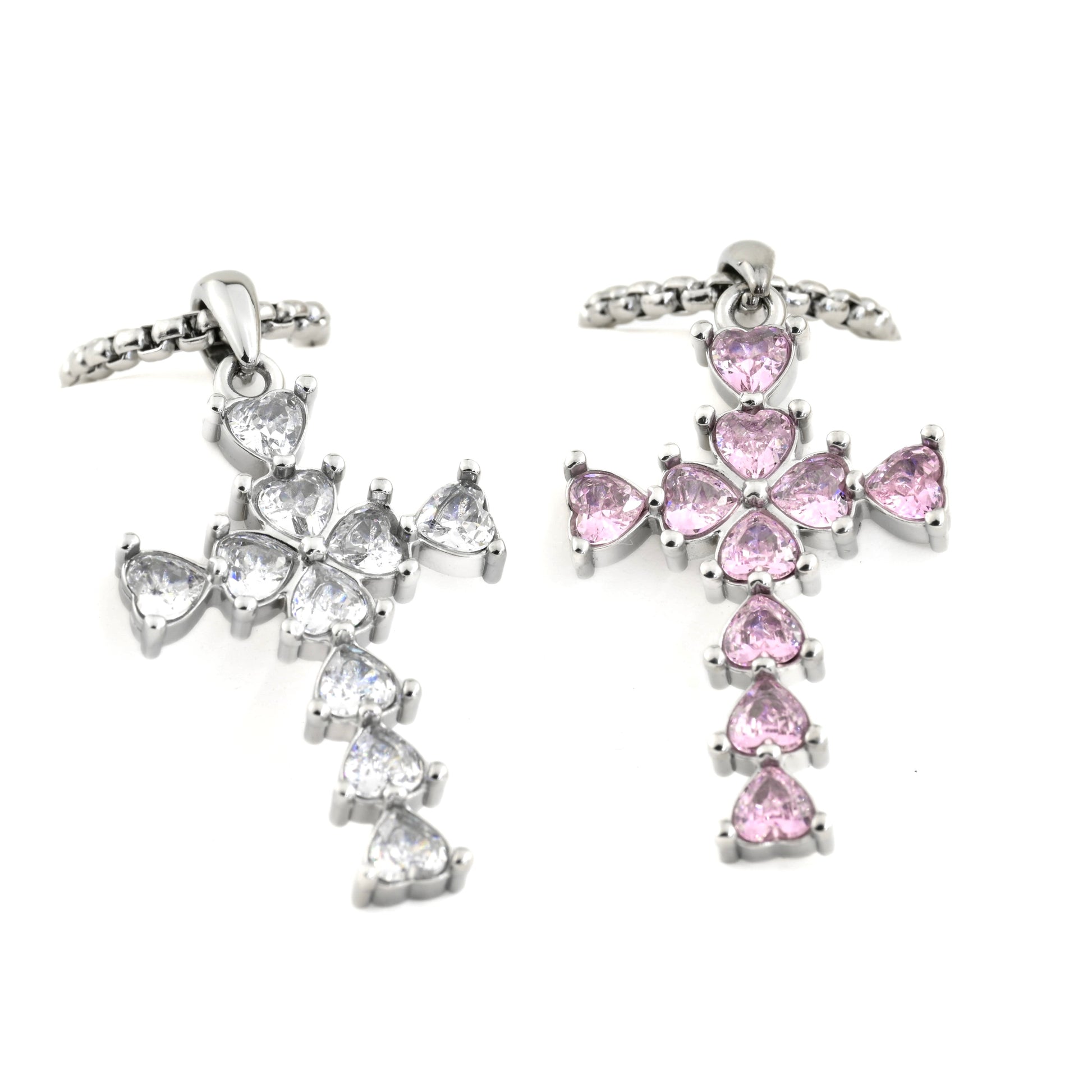 Oversized cross necklaces with pink and clear gemstones on a white background