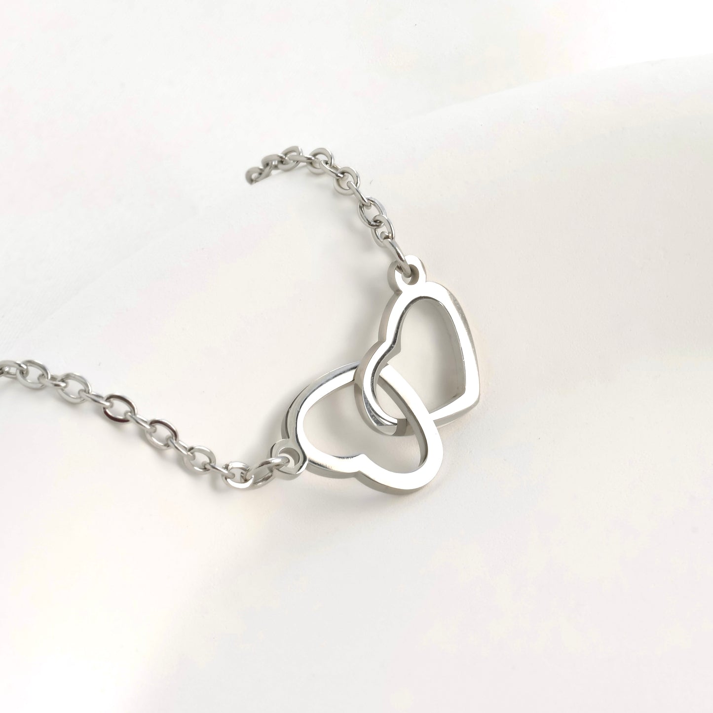 Silver heart bracelet on a white background