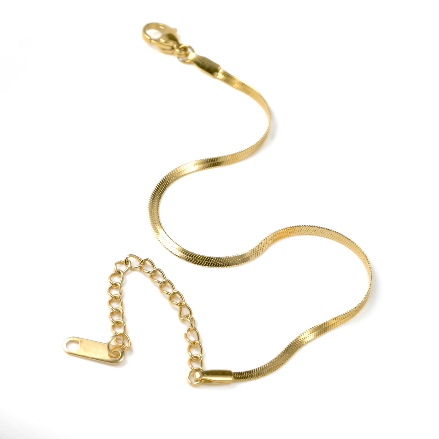 Gold herrinbone bracelet on a white background