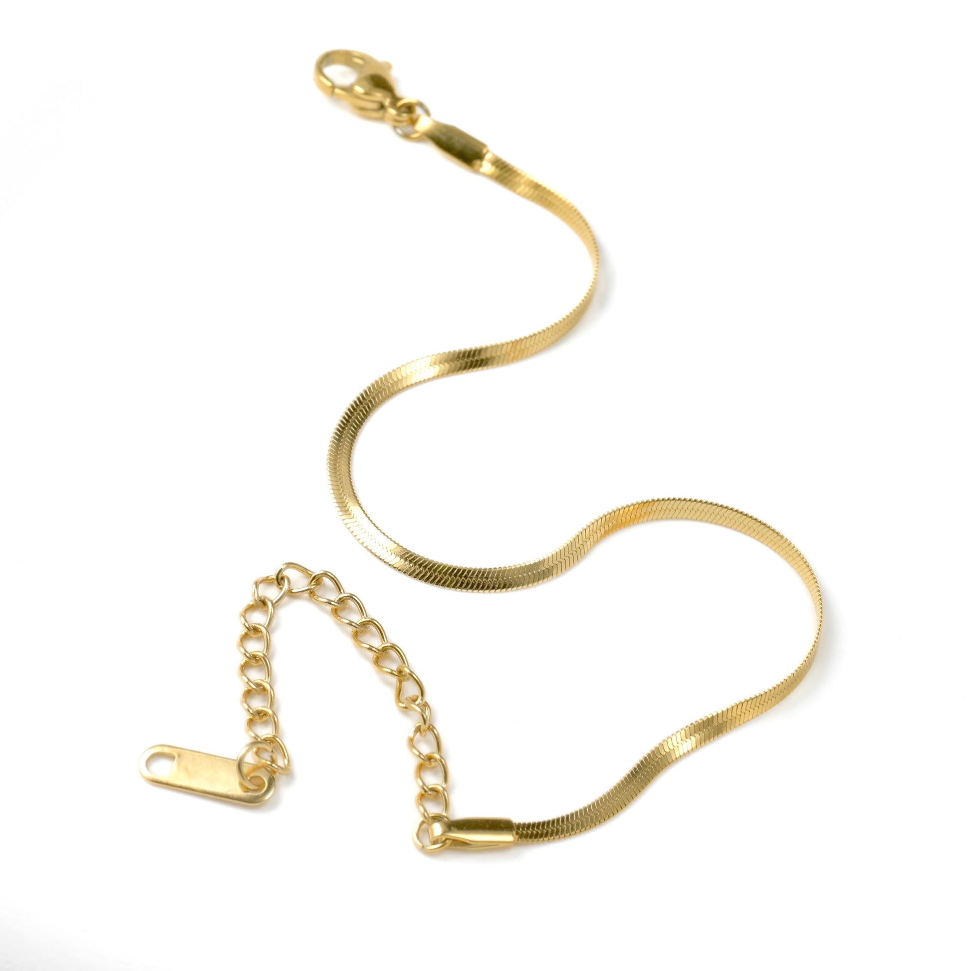 Gold herrinbone bracelet on a white background