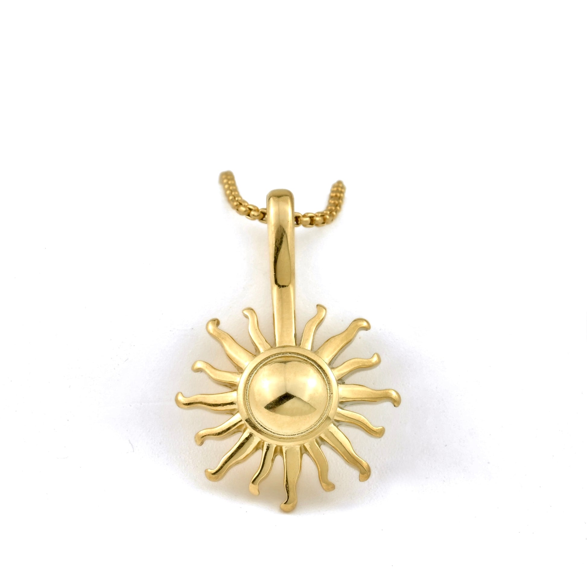 Gold sun-shaped pendant on a white background