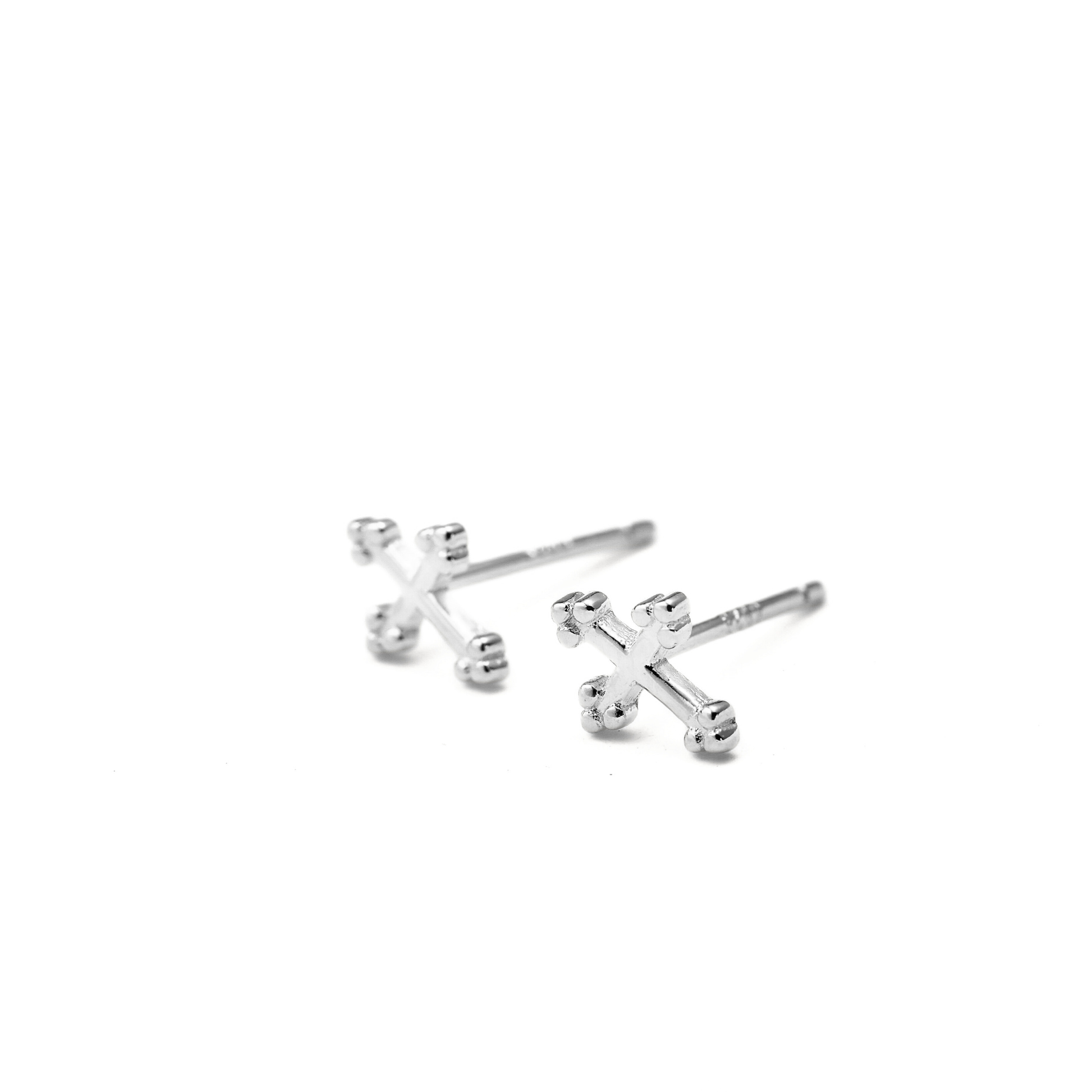 Silver cross earrings on a white background