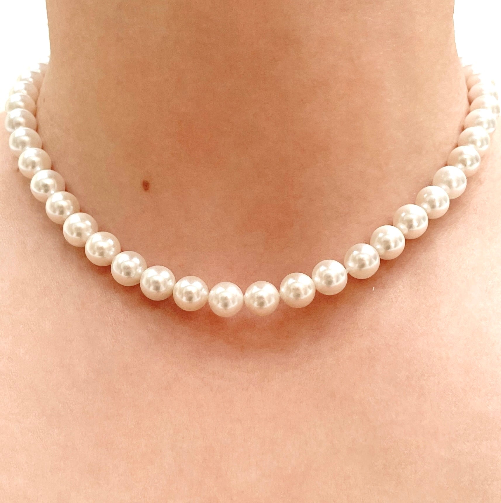 8mm Pearl necklace in 16 inches being worn on a person's neck