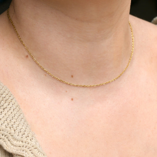 Delicate gold cable chain in 16 inches on a person