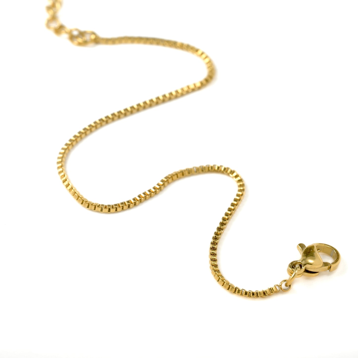 Close-up view of gold box chain bracelet on a white background