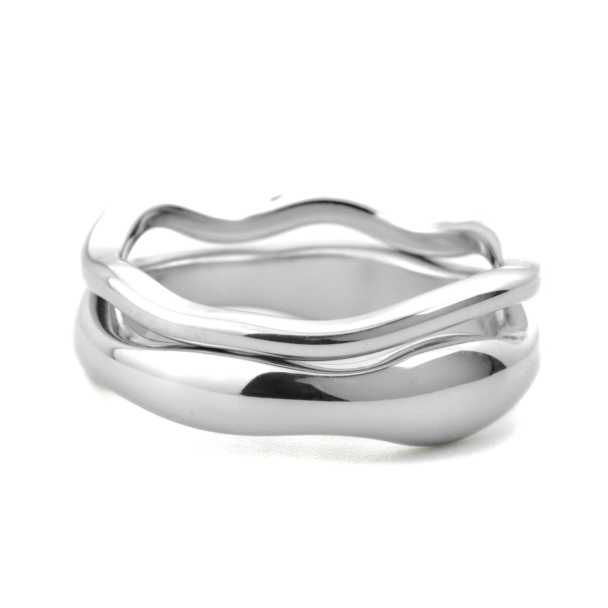 Close-up view of stacked silver ring set with an organic molten shape on a white background