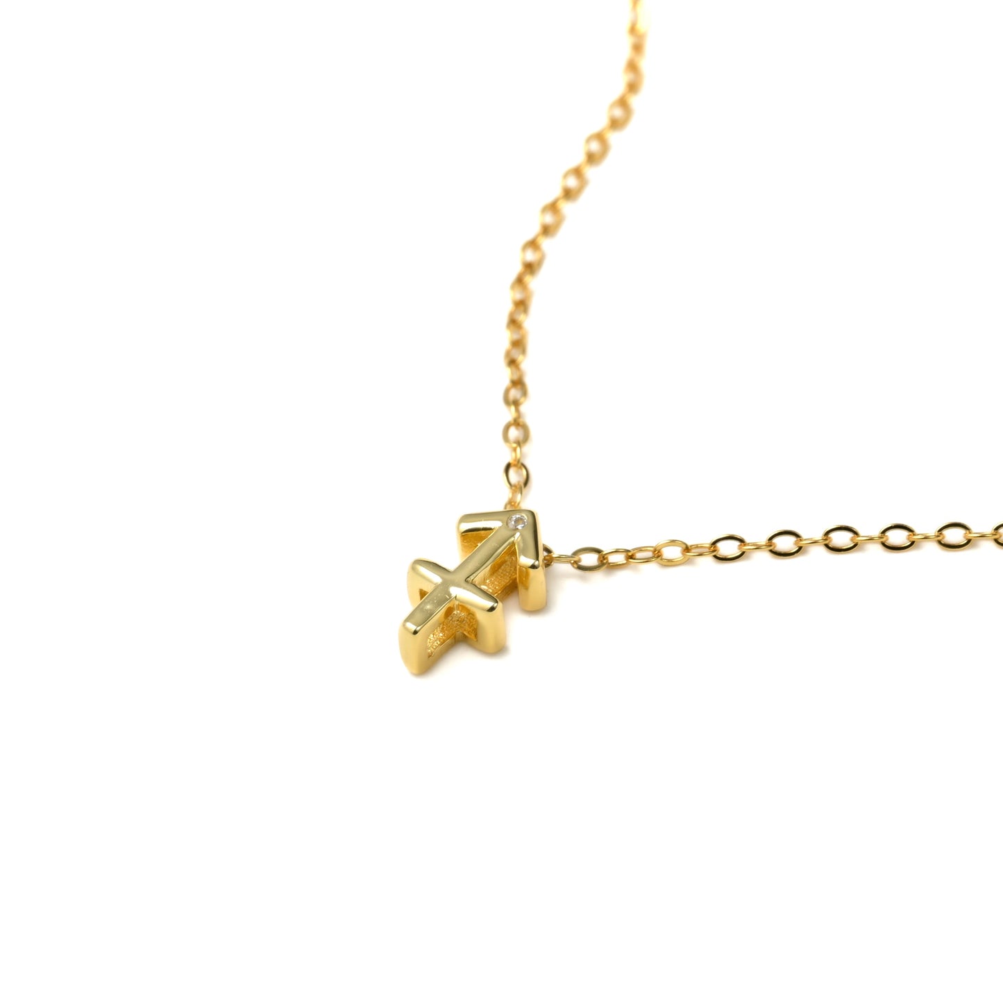 close-up of sagittarius necklace with a tiny CZ on the top of the pendant