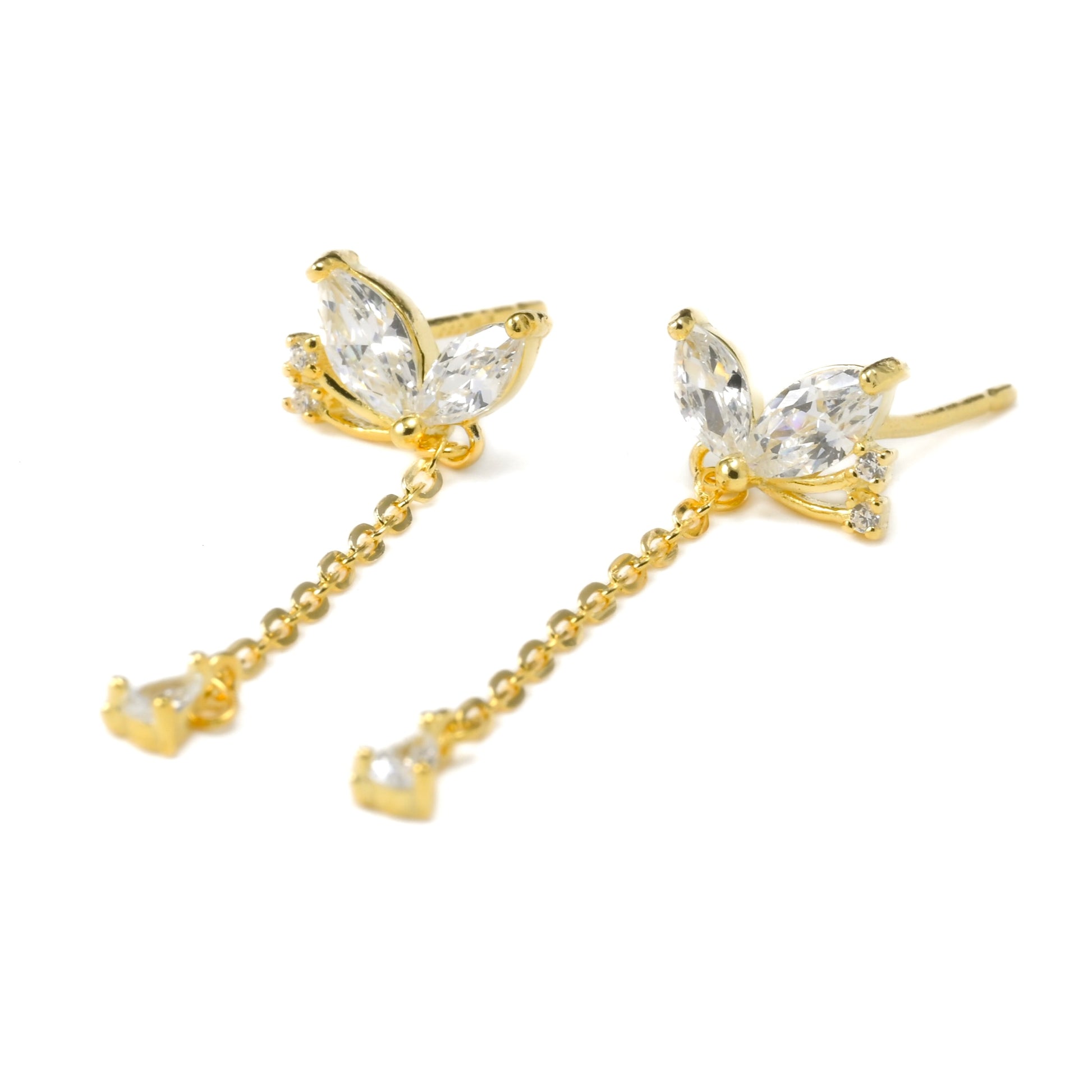 Gold dragonfly earrings with clear gemstones on a white background