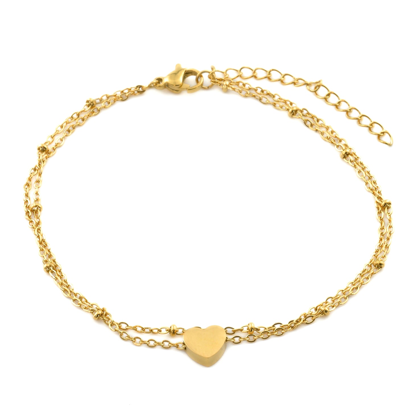 Top view of layered gold ankle bracelet with a heart charm on a white background