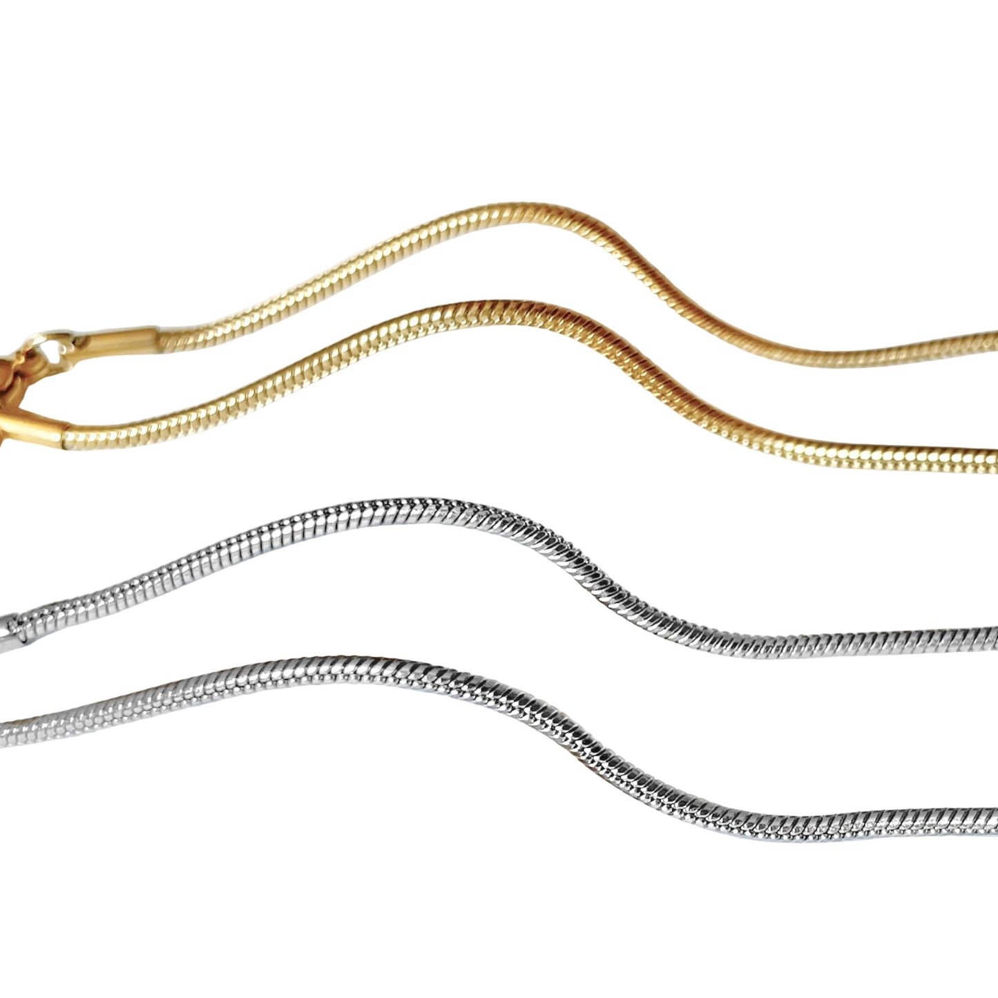 Close-up view of two gold and silver snake chain anklets on a white background
