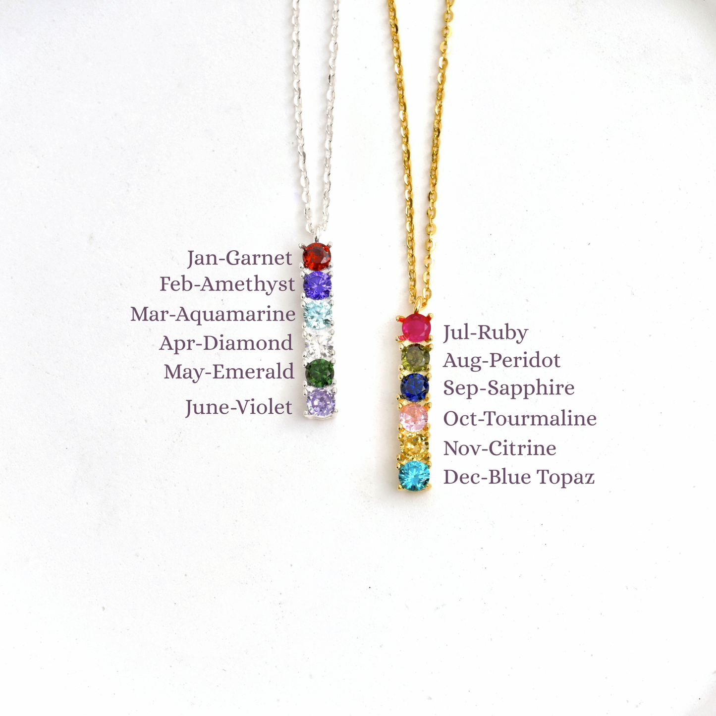 Gold and silver-tones sterling silver necklaces with gemstones corresponding to each month's birthstone on a white background.