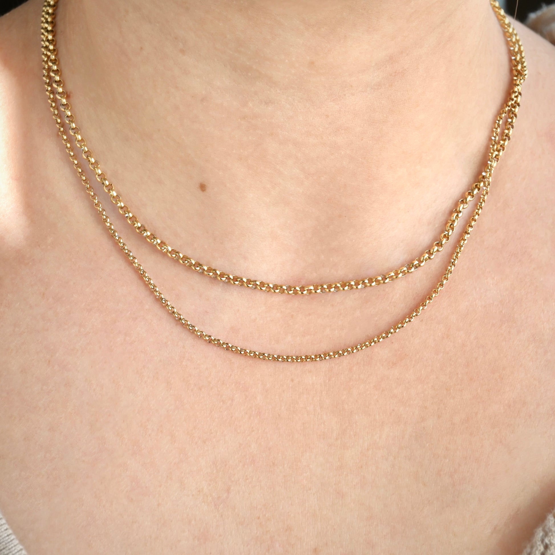 front view of gold rolo chain necklace stack